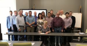 Elizabethtown Mayor Edna Berger, joined by manufacturers and others, signs a proclamation recognizing October as Manufacturing Month in Hardin County. 
