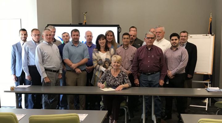 Elizabethtown Mayor Edna Berger, joined by manufacturers and others, signs a proclamation recognizing October as Manufacturing Month in Hardin County.