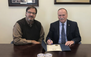 Hardin County Judge-Executive Harry Berry, pictured with Elizabethtown-Hardin County Industrial Foundation President and COO Rick Games, signs a proclamation recognizing October as Manufacturing Month in Hardin County. 